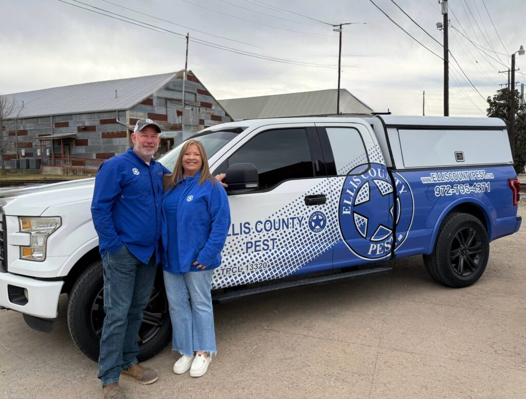 The White family, owners of Ellis County Pest Services, beside a company truck